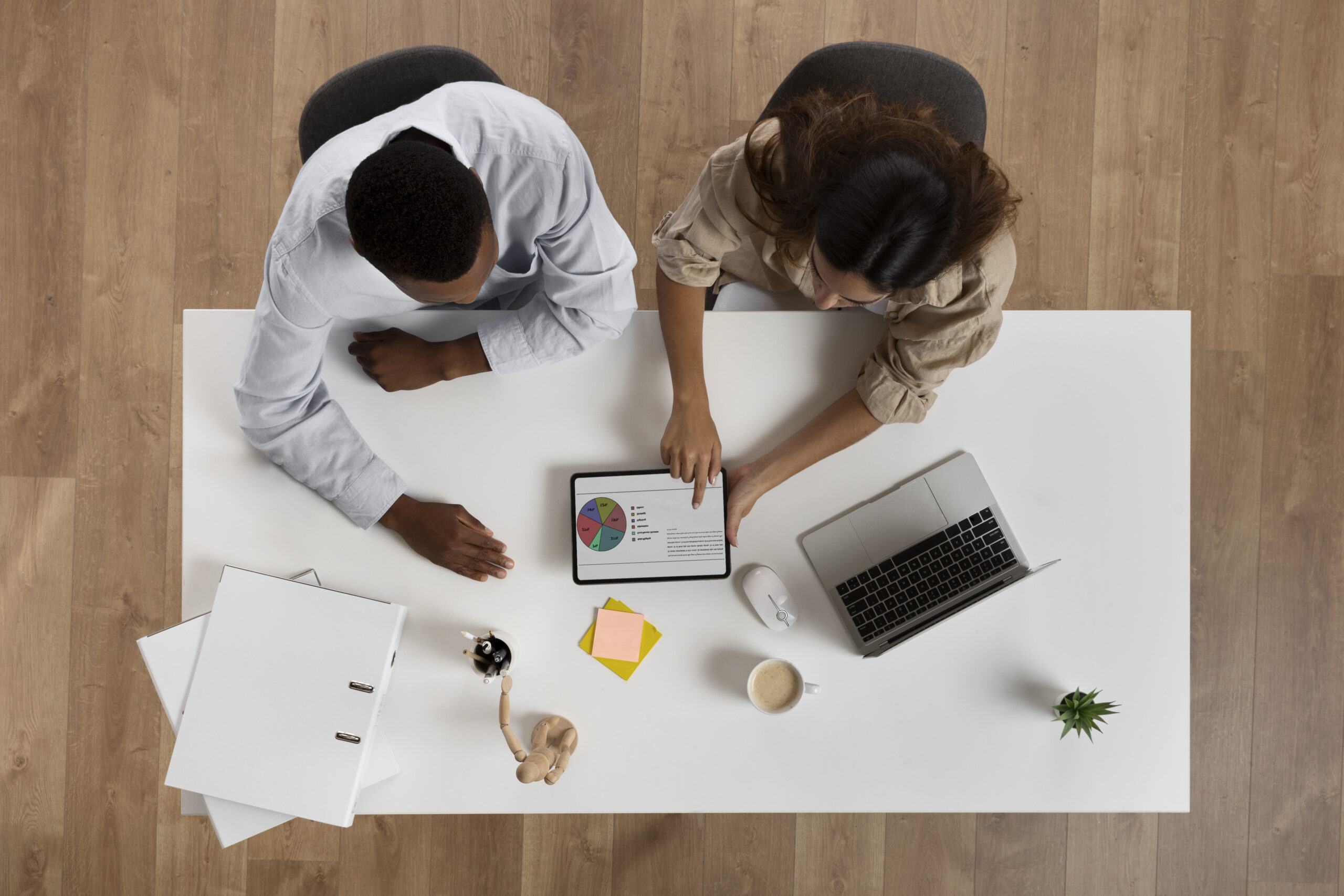 top-view-colleagues-working-desk